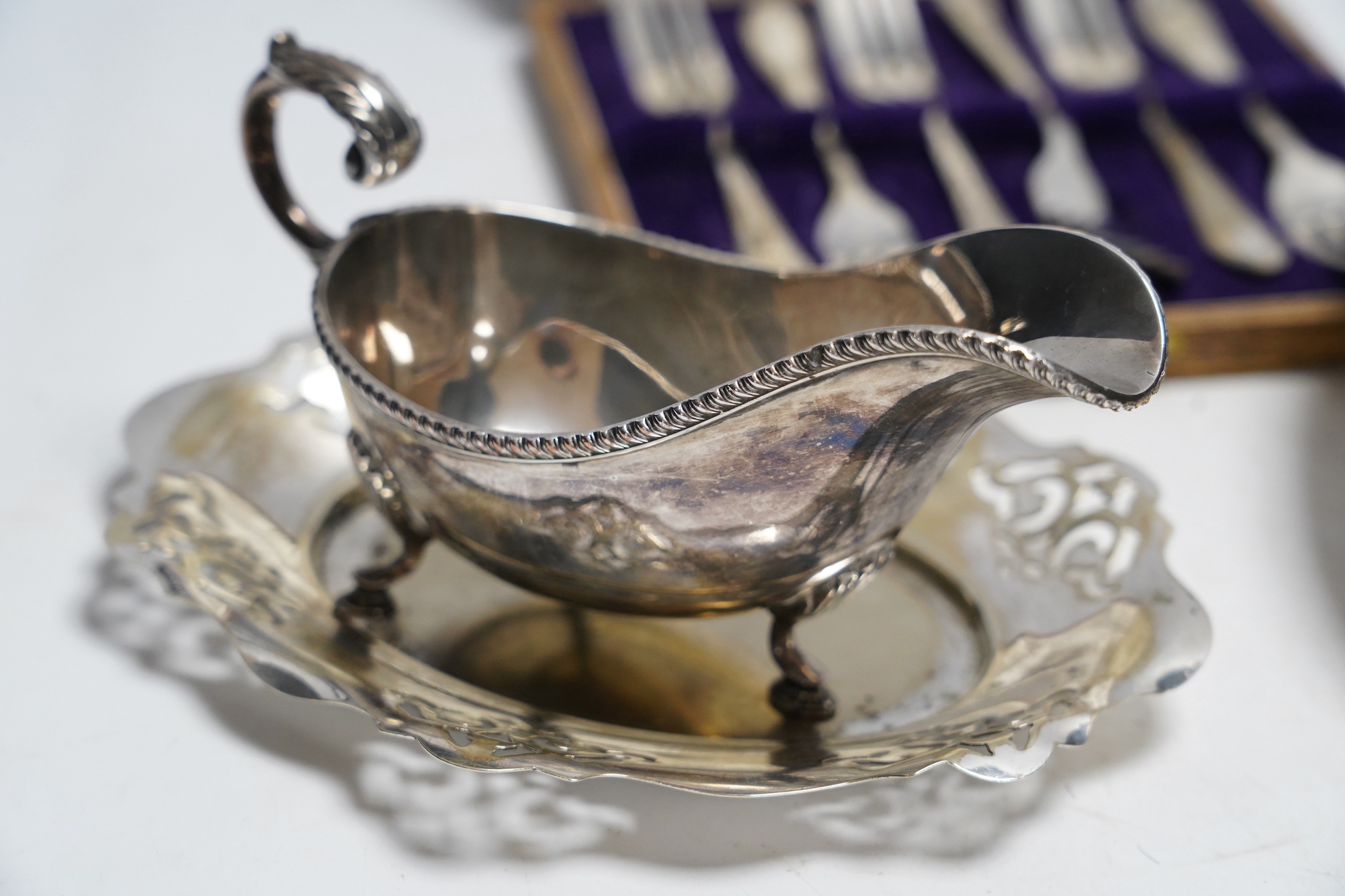 Assorted plated ware including a salver, a sauceboat and a cased set of forks